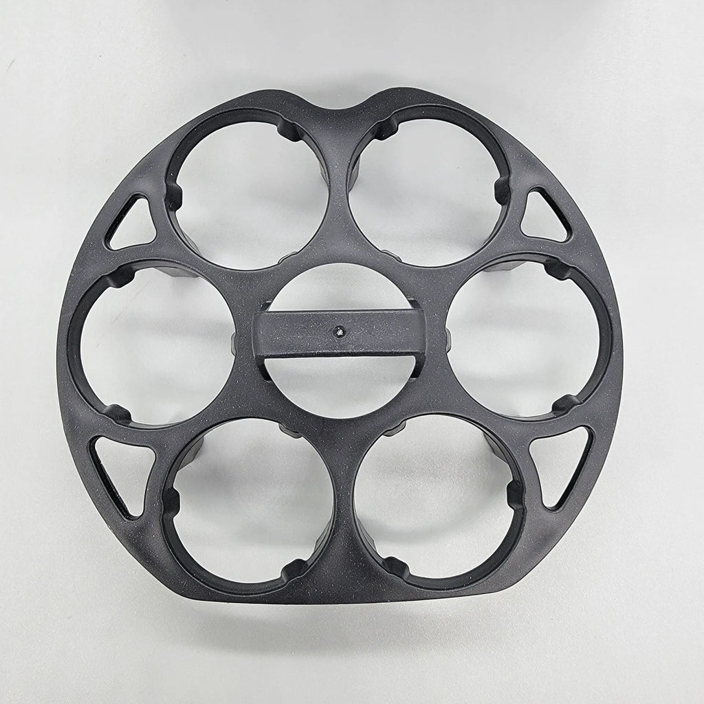 Black plastic egg holder basket rack for a cooking machine on a white background.