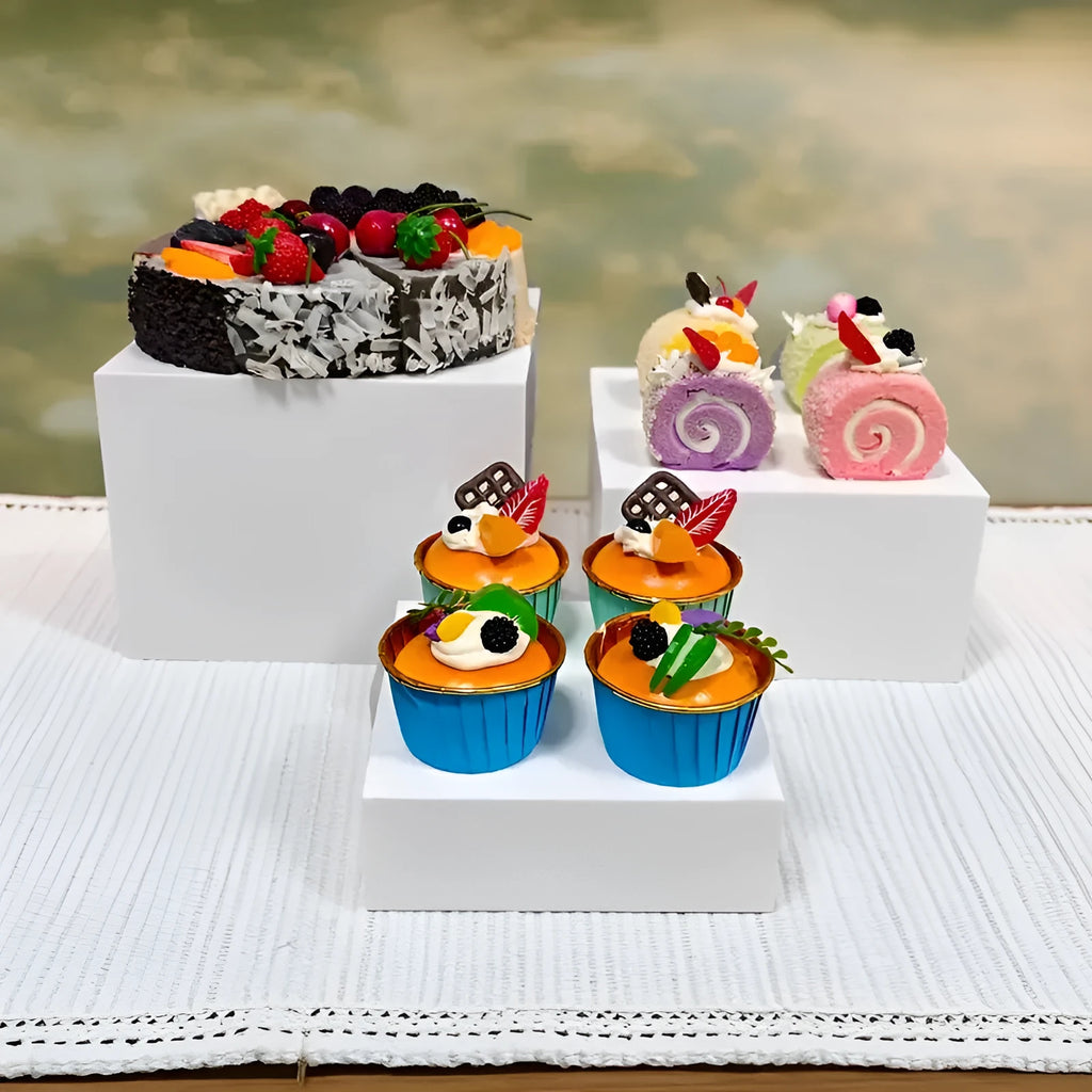 White plastic cube dessert display stand with six individual pieces for cake and confectionery presentation
