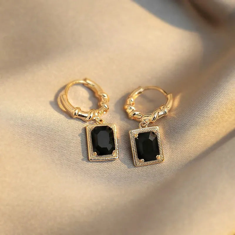 A pair of black geometric quadrilateral earrings with zircon accents on a copper base, retro French court style.