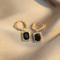 A pair of black geometric quadrilateral earrings with zircon accents on a copper base, retro French court style.
