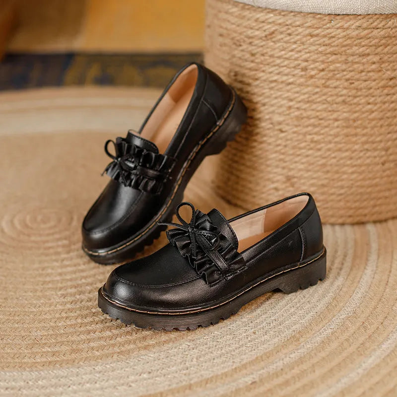 Women's black leather ankle boots with round toe and chunky flat heel, British style