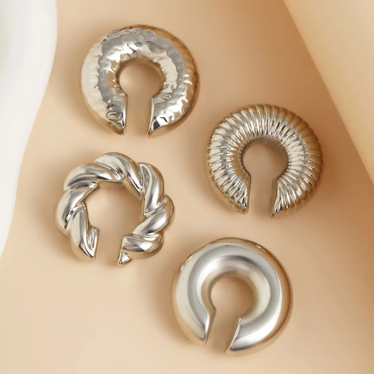 Set of four geometric non-pierced ear clips in gold and silver colours