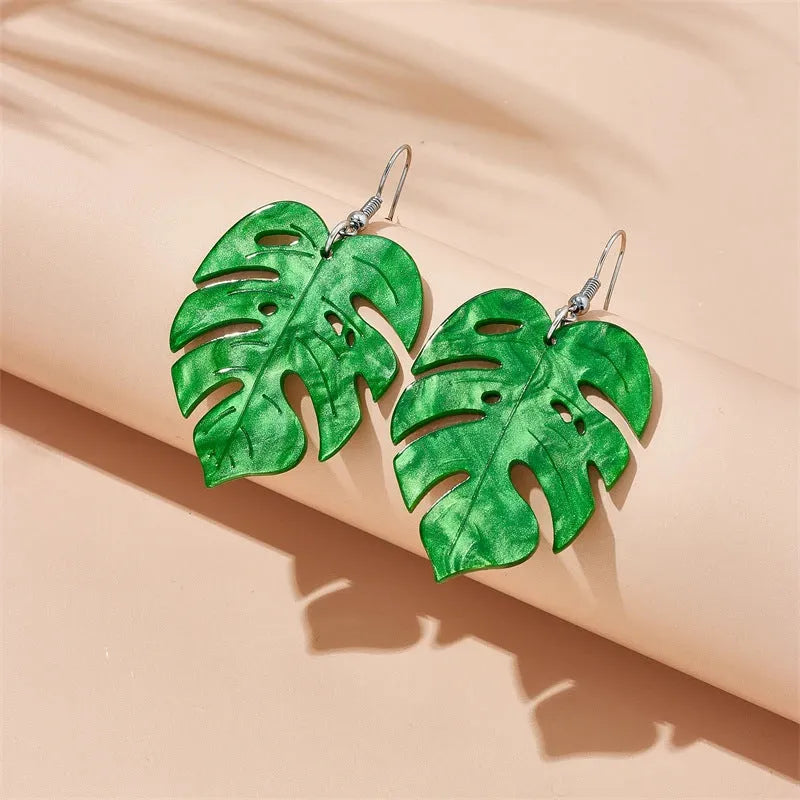 Acrylic drop earrings with a carved coconut and jackfruit design on a metal hook, shown in multiple colour variants.