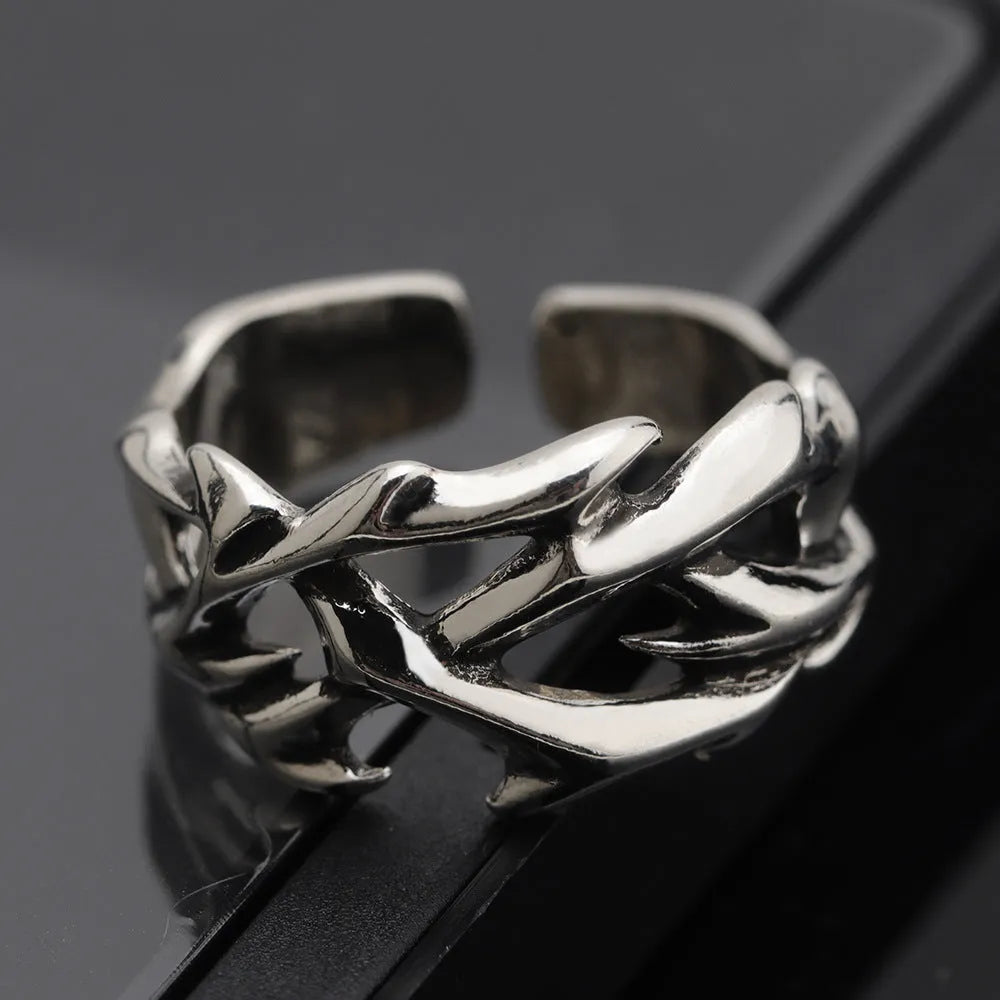 Geometric copper ring with thorn and flower design featuring adjustable opening