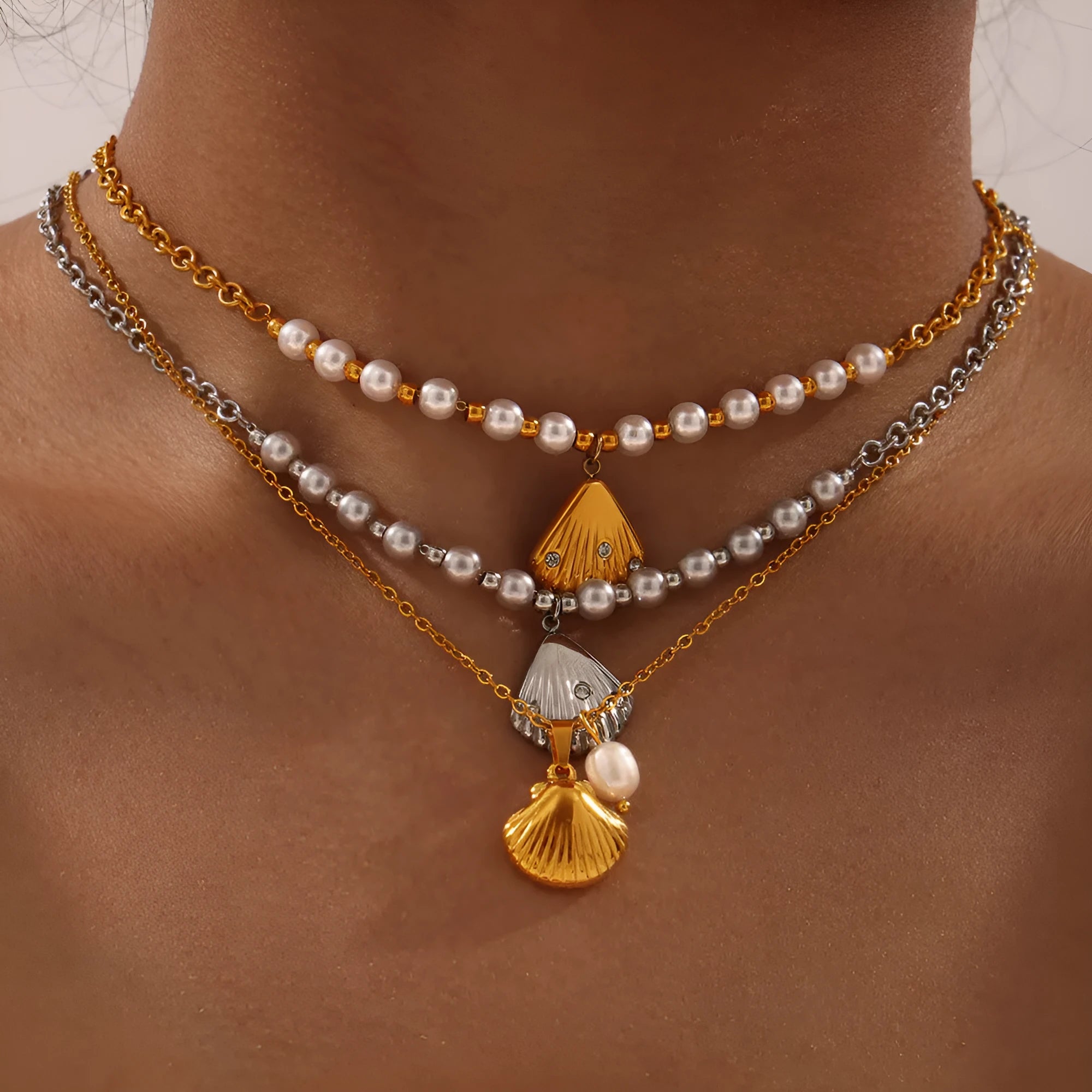 Gold titanium steel women's necklace featuring a French vintage shell pendant with freshwater pearl beads on an O-chain.