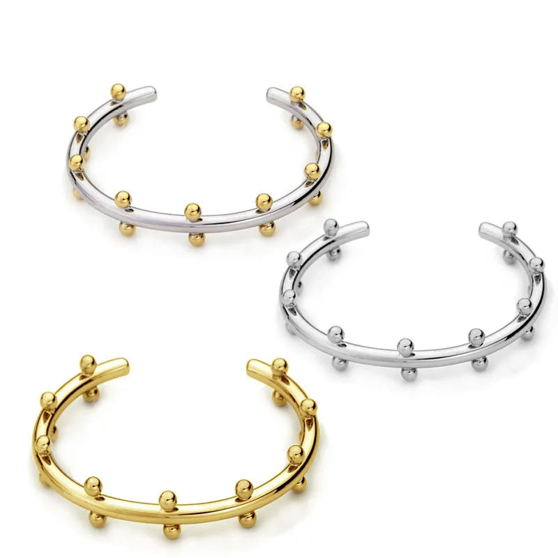 C-shaped textured rivet bean bead charm bracelet in gold, steel, or two-tone finish on an alloy chain.