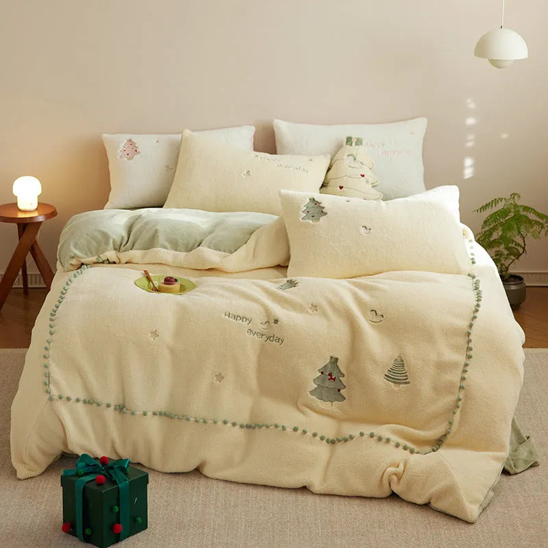 Milk fibre four-piece bed linen set with green Christmas tree pattern on a quilt cover and pillowcase.