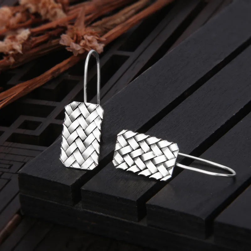 Silver geometric diamond-shaped earrings with a woven plaid pattern for women.