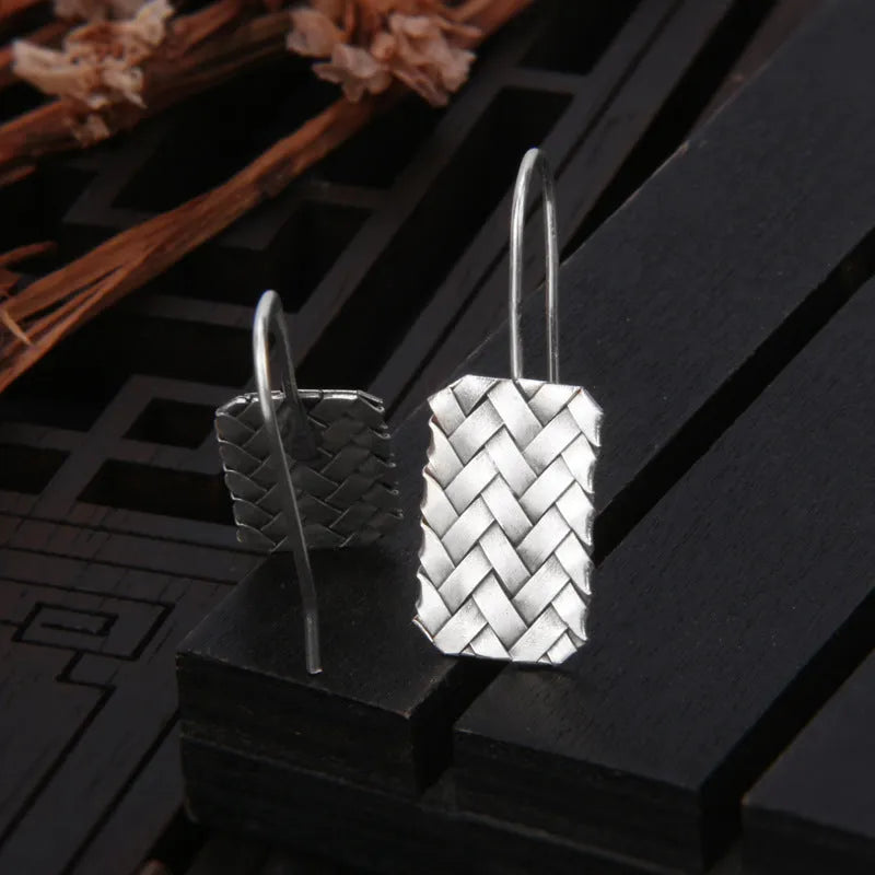 Silver geometric diamond-shaped earrings with a woven plaid pattern for women.