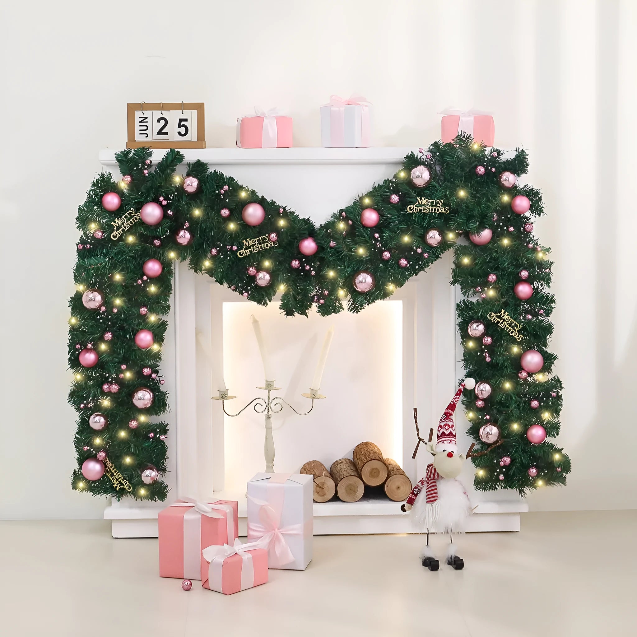 Pink artificial Christmas rattan vine garland with fairy lights draped on a mantelpiece