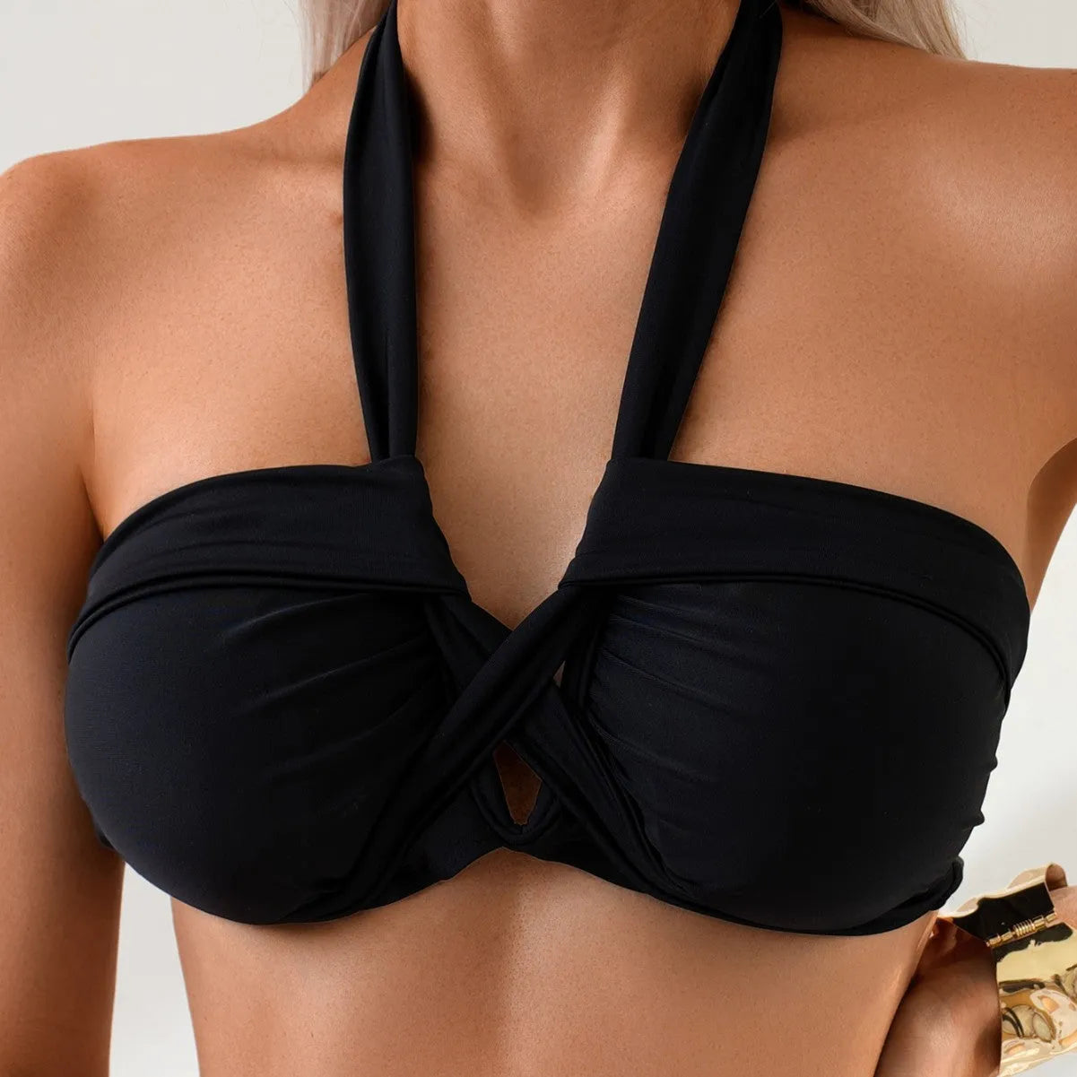 Black solid colour backless one-piece swimsuit for women on a mannequin.