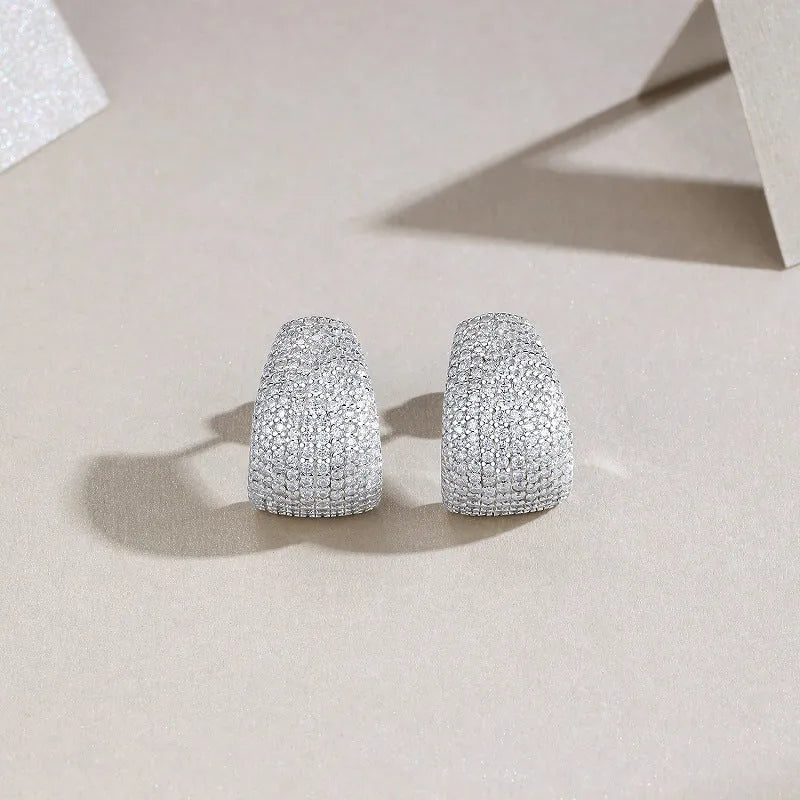 Geometric S925 sterling silver ear studs with moissanite centre on a white background.