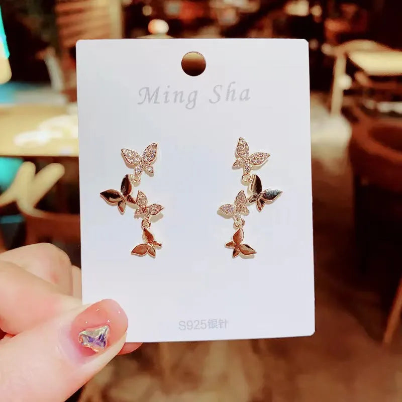 Women's gold-coloured copper butterfly earrings with four drop charms