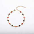 Stainless steel heart-shaped bracelet with gold plating in multiple colour options on a wrist.