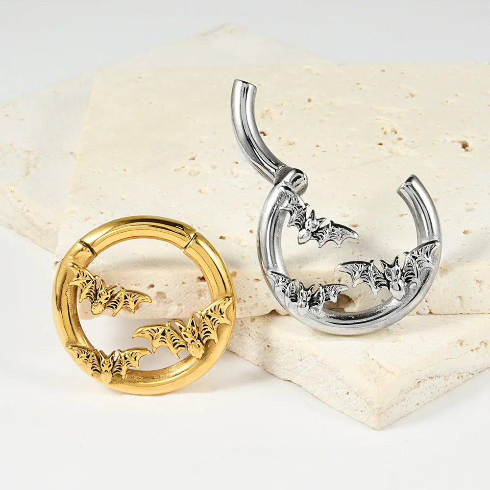 A pair of silver-toned fashion earrings with a geometric totem pattern design on a white background.