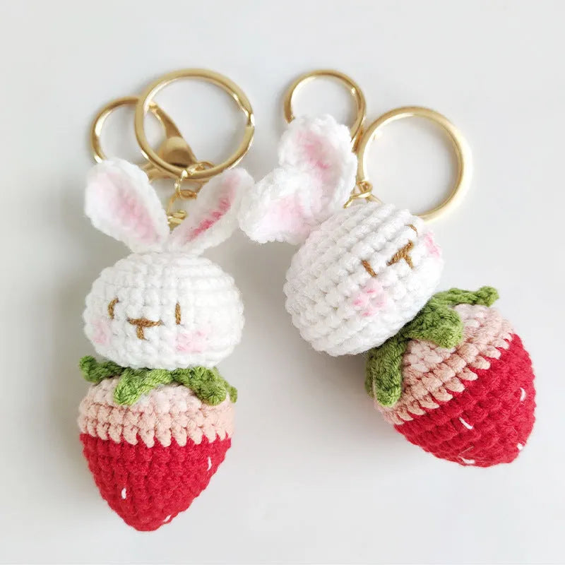 White hand-woven wire pendant with a rabbit strawberry cartoon design and a key loop.