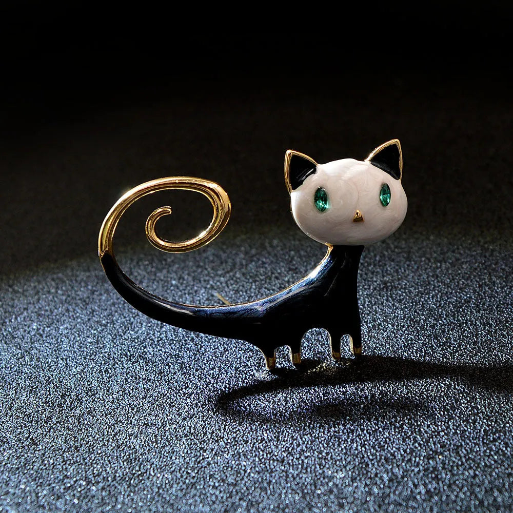 Personalised white and orange alloy cat brooch with painted detailing and a long tail.