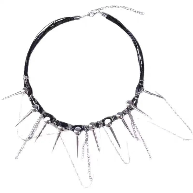 Close-up of a leather necklace with round beads, a winding tassel, and silver rivet details on a dark background.