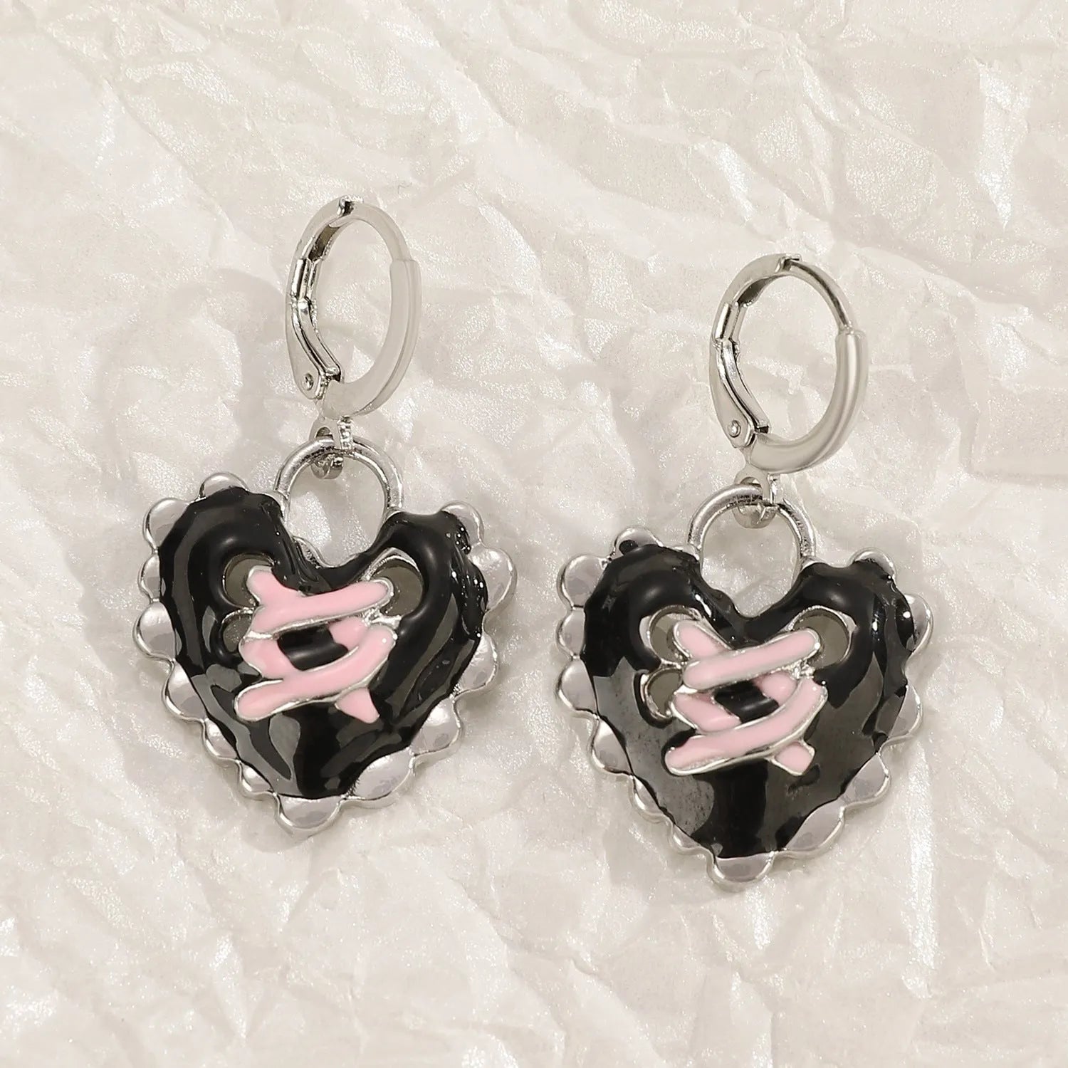 Women's alloy earrings with cross and heart designs in white and antique silver colour variants