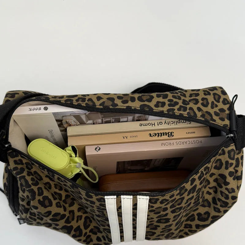 Sports style shoulder messenger bag in leopard print pattern with cross-body strap