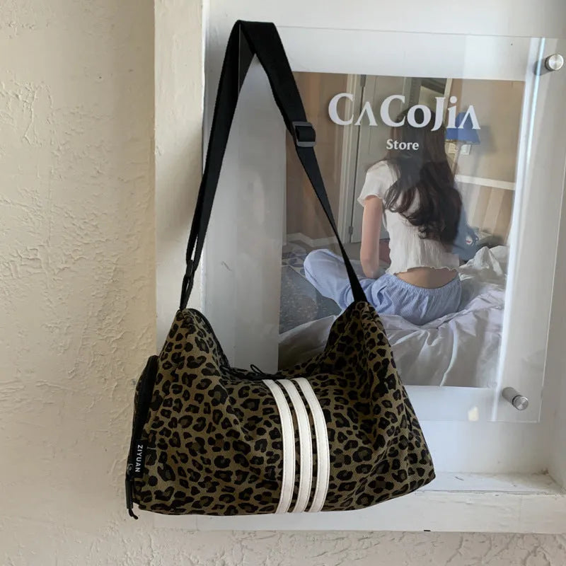 Sports style shoulder messenger bag in leopard print pattern with cross-body strap