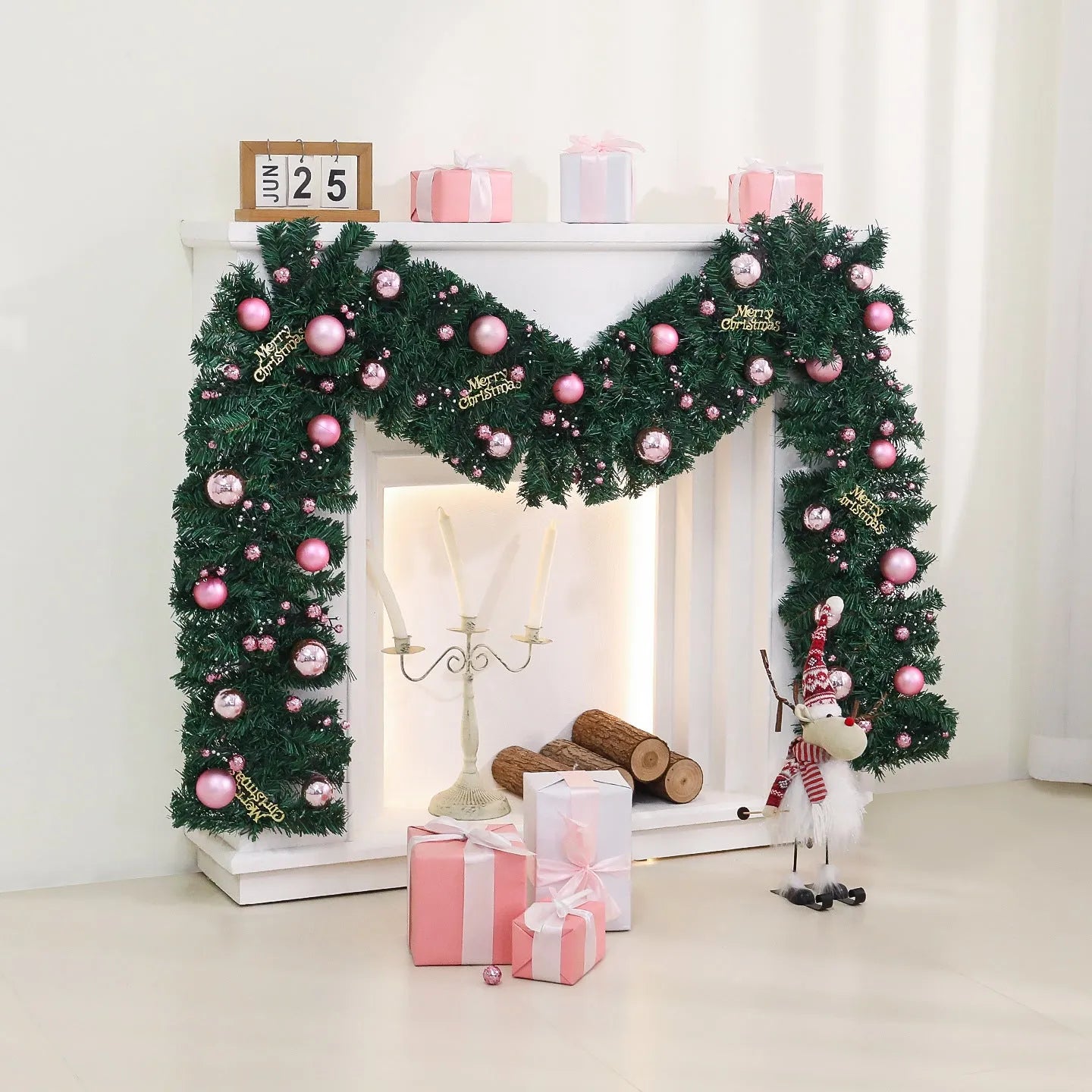 Pink artificial Christmas rattan vine garland with fairy lights draped on a mantelpiece