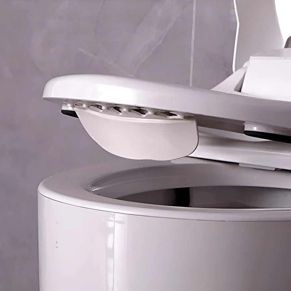 White PVC children's toilet training splash guard placed on a toilet seat.