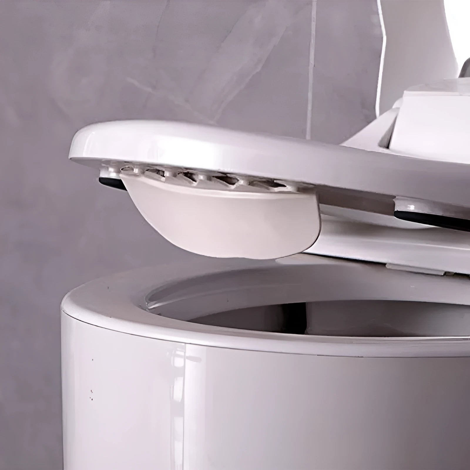 White PVC children's toilet training splash guard placed on a toilet seat.