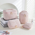 Four-piece polyester makeup bag set in cube style with modern simple design