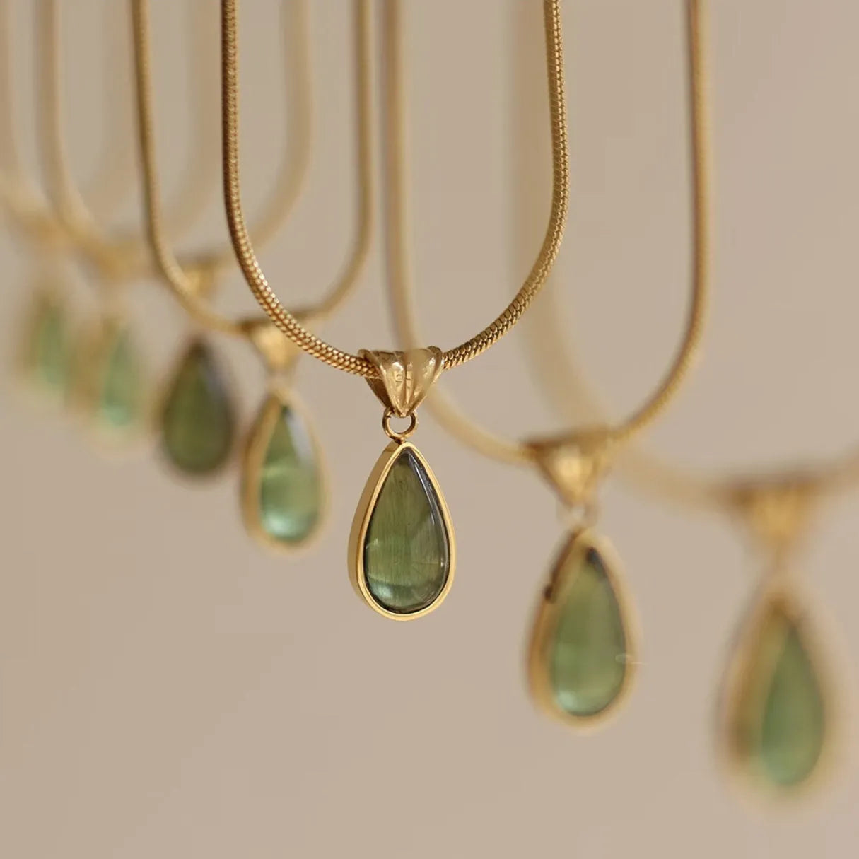 Retro titanium steel necklace with a blue or green water drop pendant featuring a mixed gem inlay.