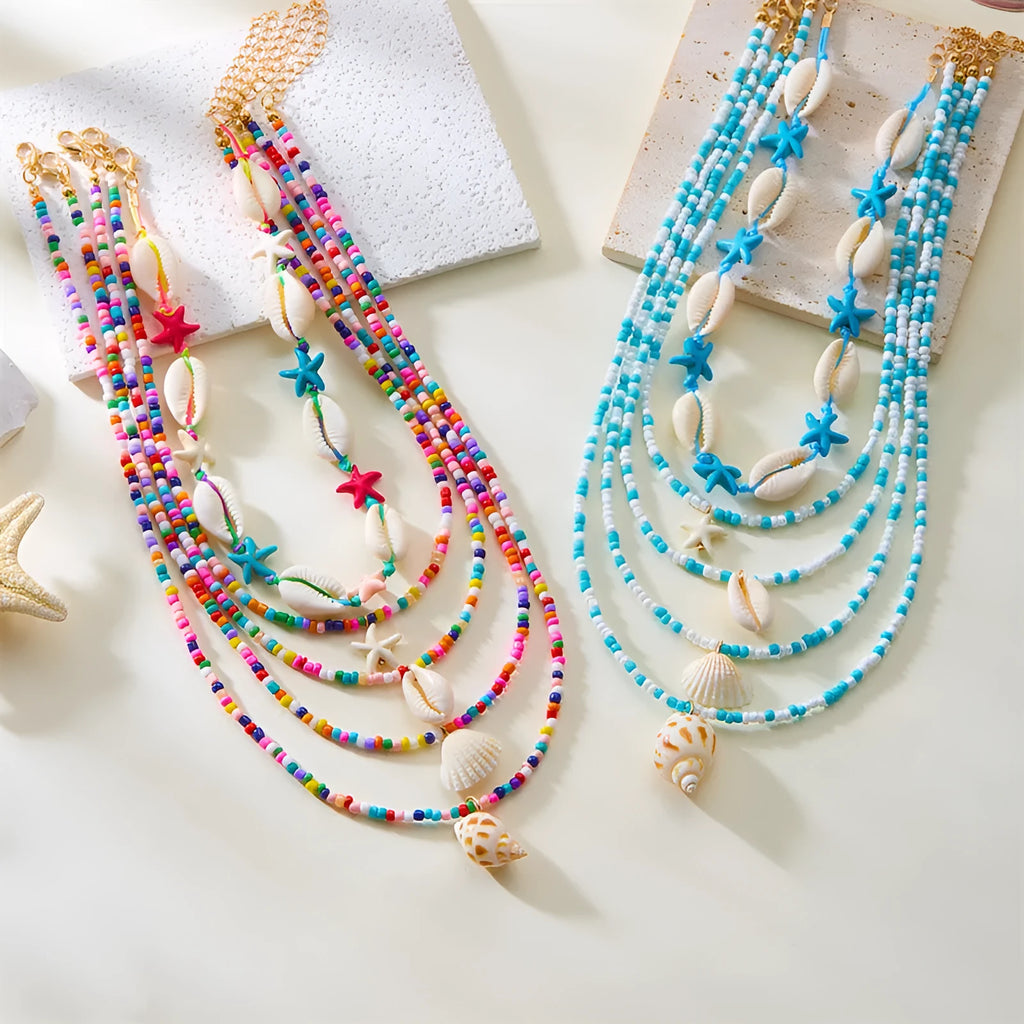 Women's five-layer shell and conch bead necklace set with adjustable chain on blue background