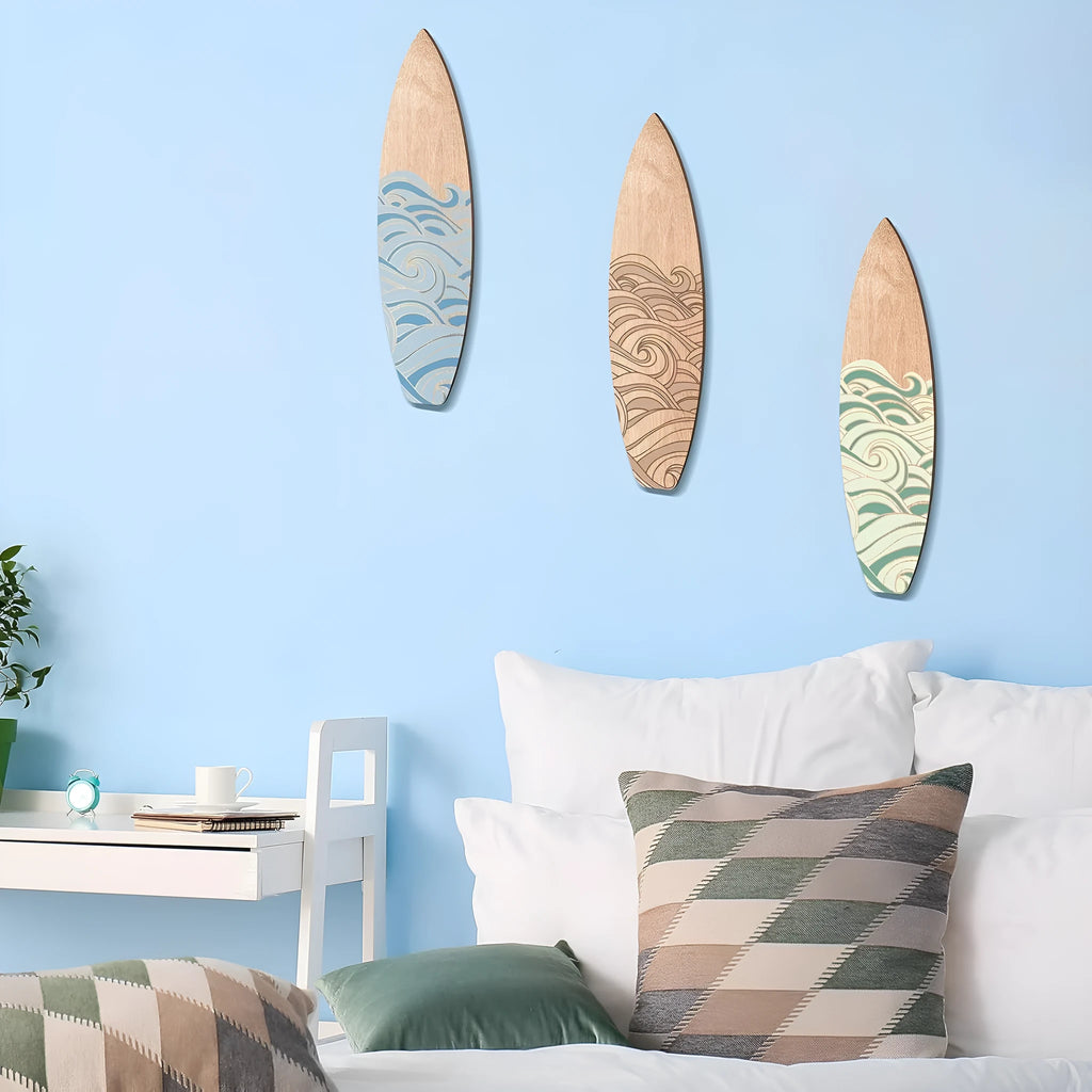 Three identical wooden surfboard wall decorations made from boxwood on a wall.