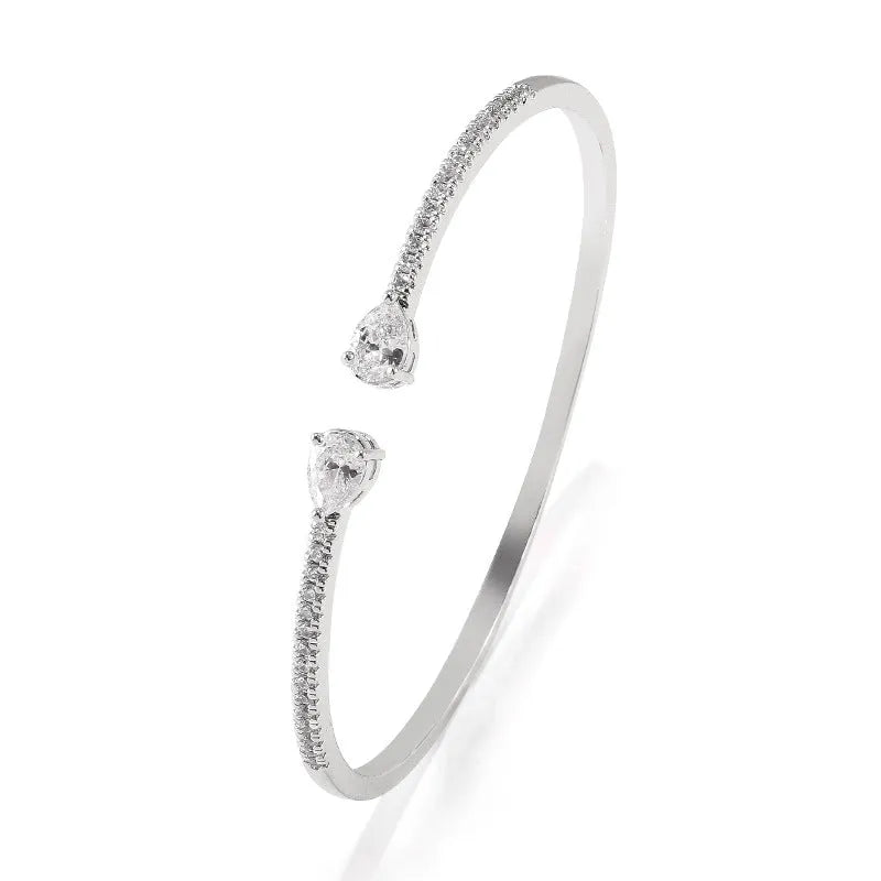 Personalised multi-zircon bracelet in copper, showing detailed inlaid stonework in a simple band style.