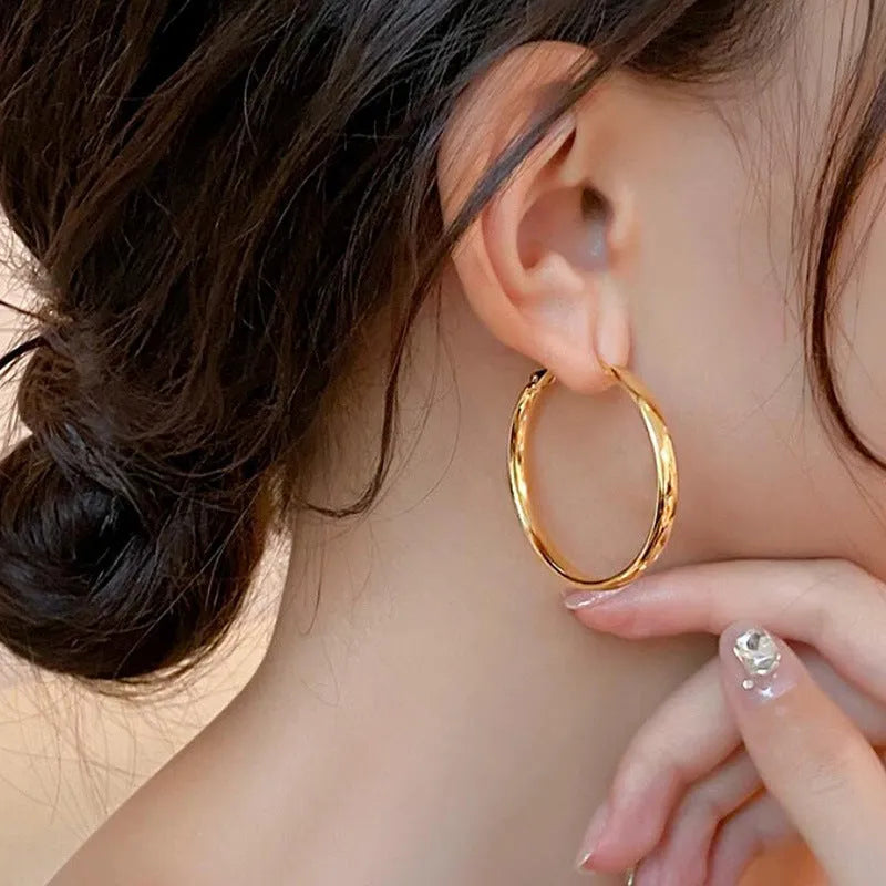 Circular 40mm diameter metal earrings with gold or silver electroplated finish