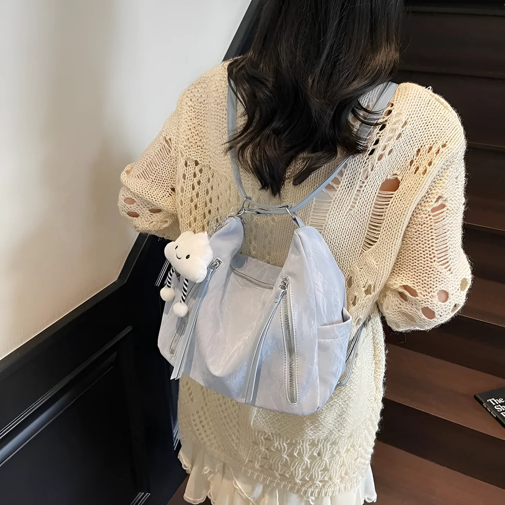 Women's soft PU fashion backpack in blue colour with pendant accessory attached