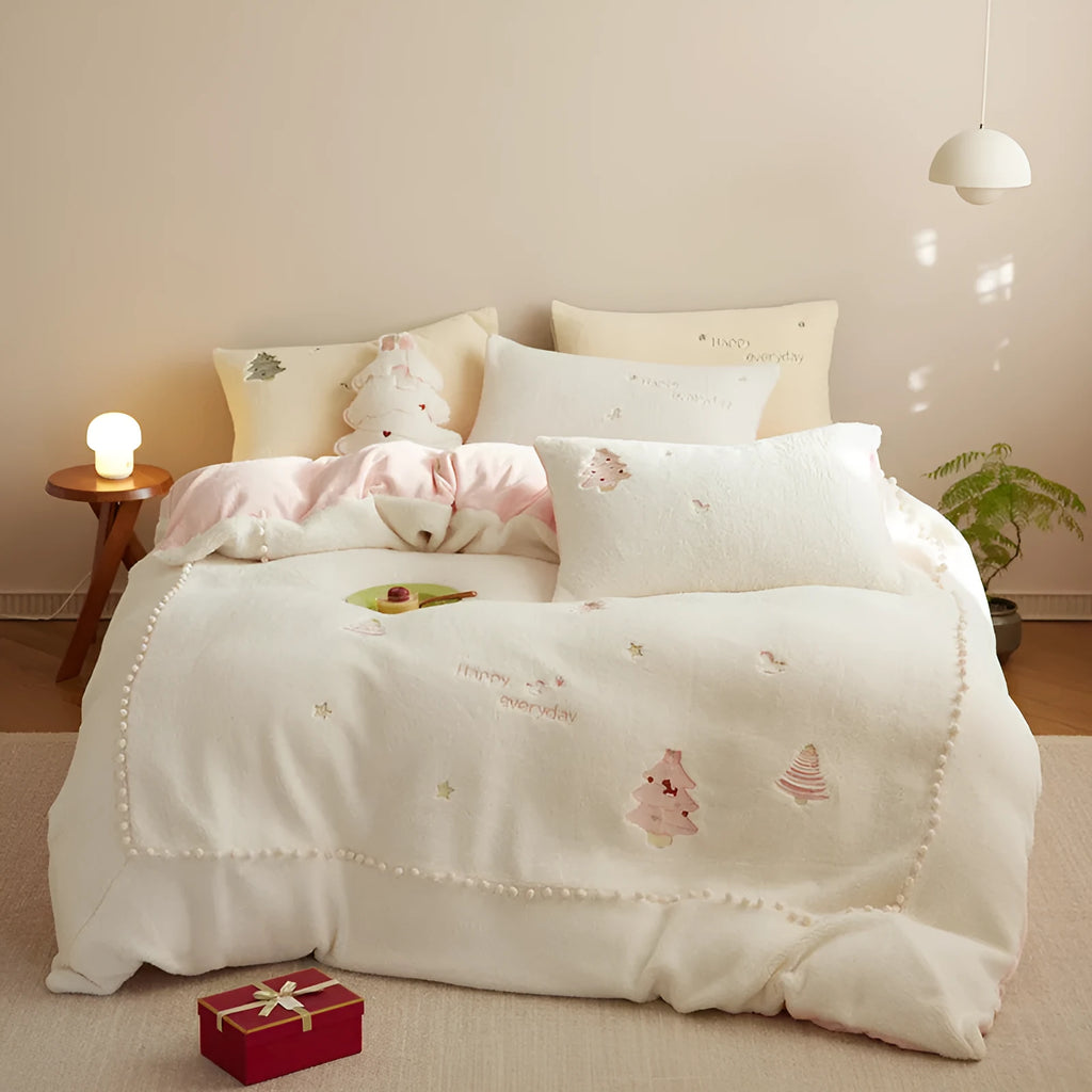 Milk fibre four-piece bed linen set with green Christmas tree pattern on a quilt cover and pillowcase.