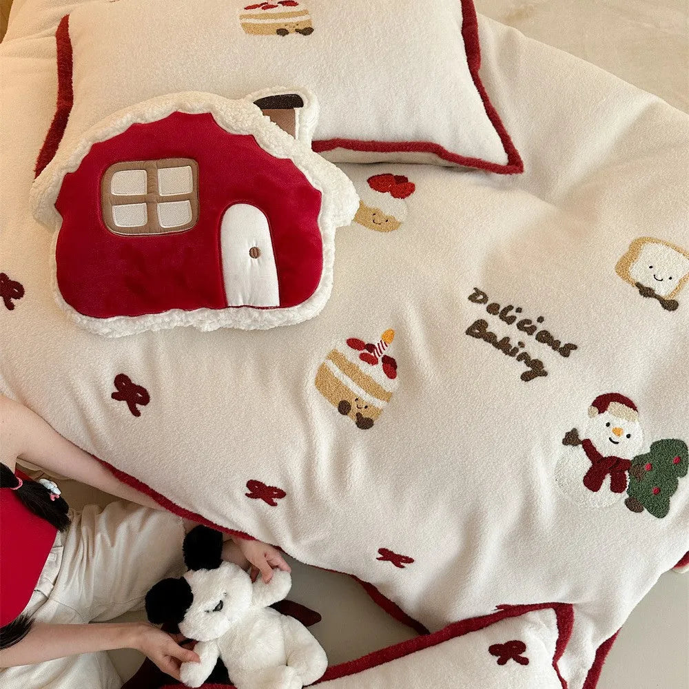 Winter Christmas cartoon patterned bed linen four-piece set on a bed, showing duvet cover and pillowcases.