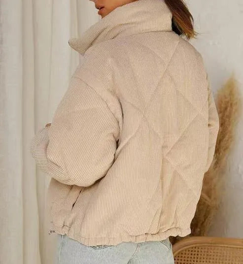 Apricot coloured women's corduroy jacket with stand collar and front zip, showing textured fabric.