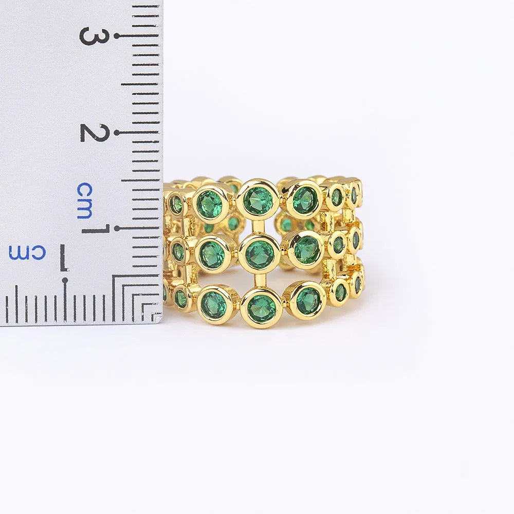 Wide copper ring with green zircon stones and gold plating