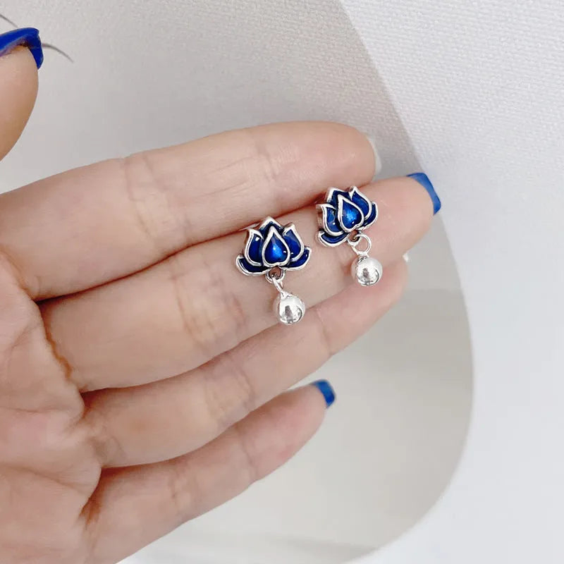 Blue Lotus alloy earrings with flower shape and lotus seedpod tassel detailing