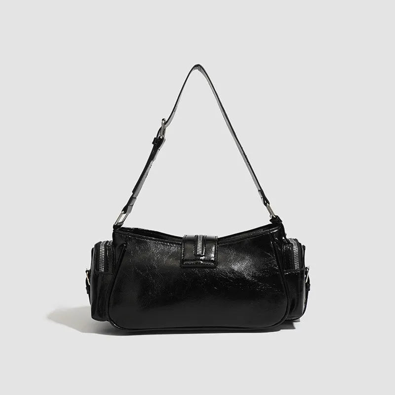 Black dumpling-shaped retro handbag with oil wax PU leather showing three-dimensional pockets and shoulder strap