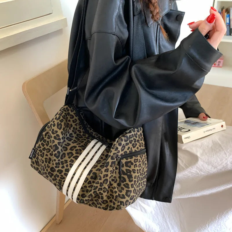 Sports style shoulder messenger bag in leopard print pattern with cross-body strap