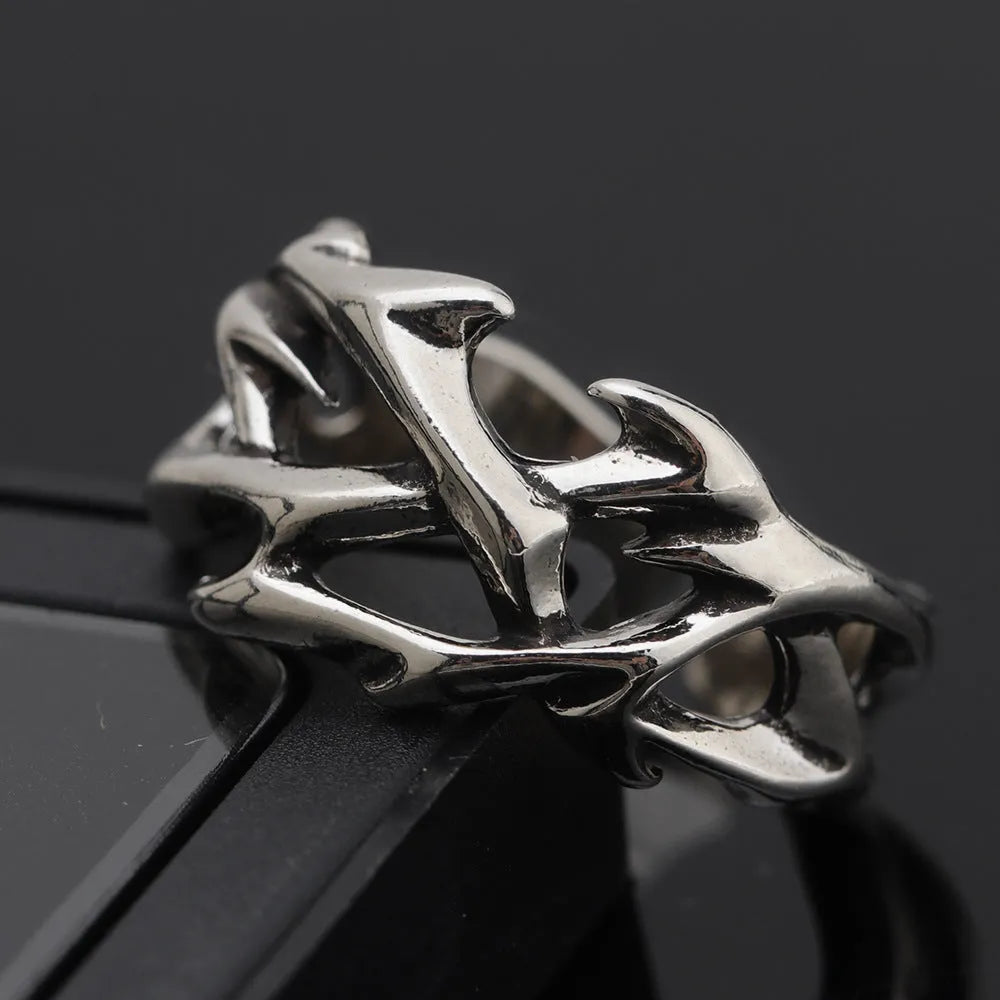 Geometric copper ring with thorn and flower design featuring adjustable opening