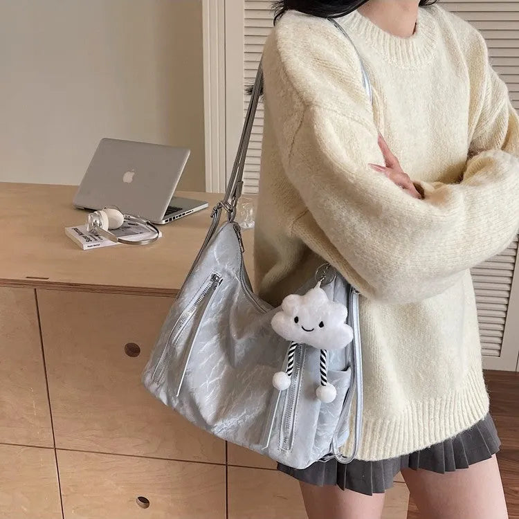 Women's soft PU fashion backpack in blue colour with pendant accessory attached