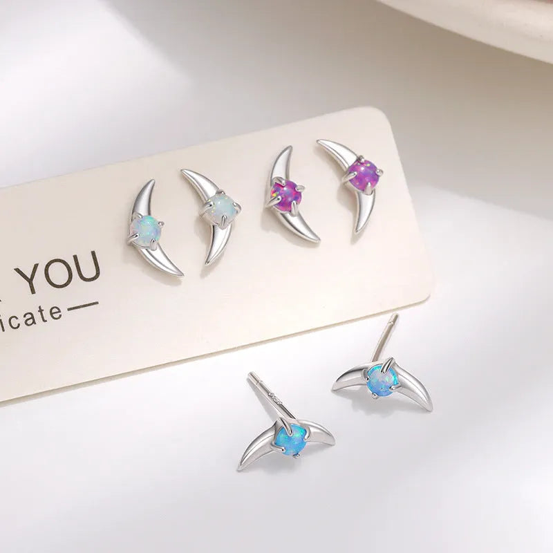 Geometric shaped 925 silver earrings with gold plating and a blue stone.