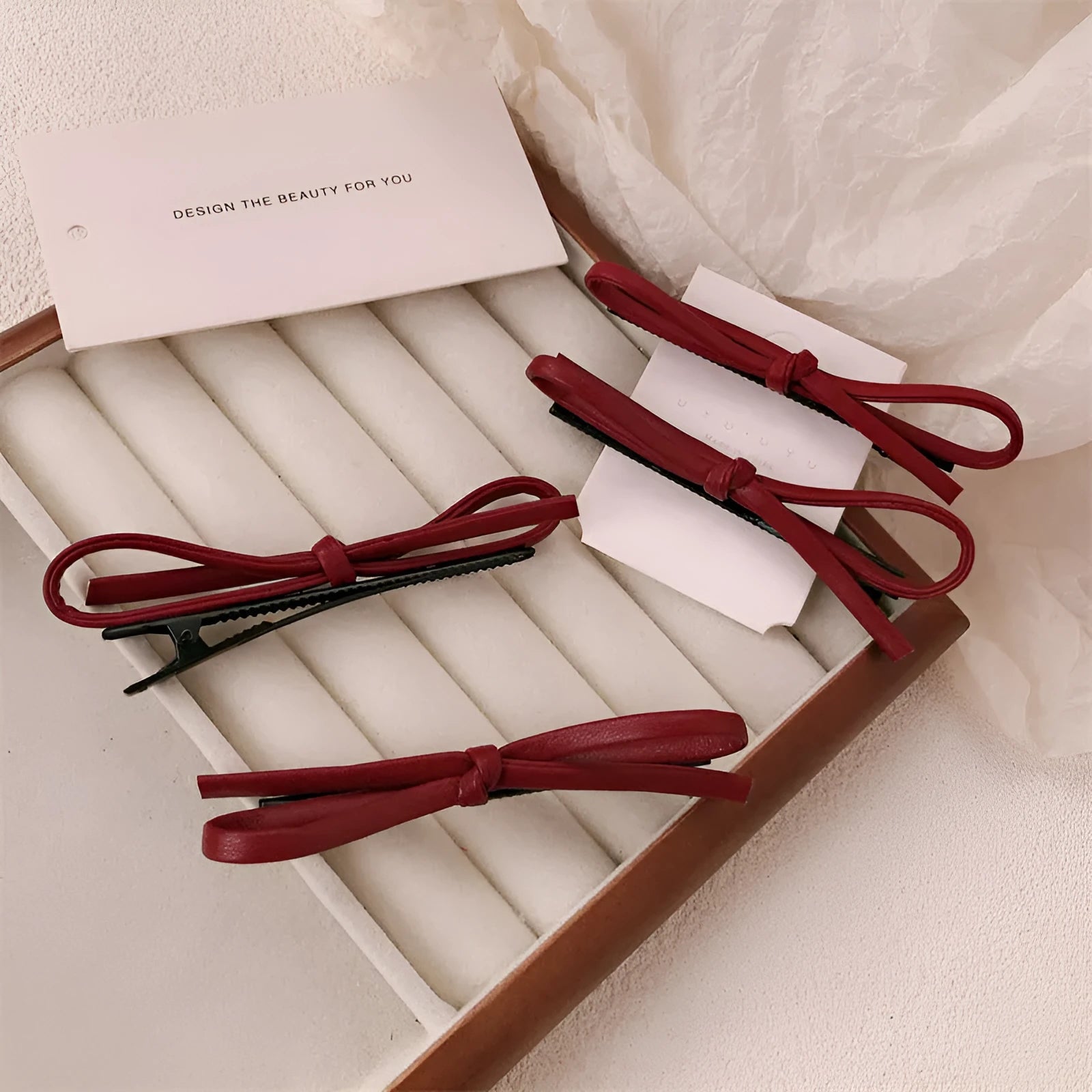Wine red leather bow barrettes for women with handmade construction and clip mechanism