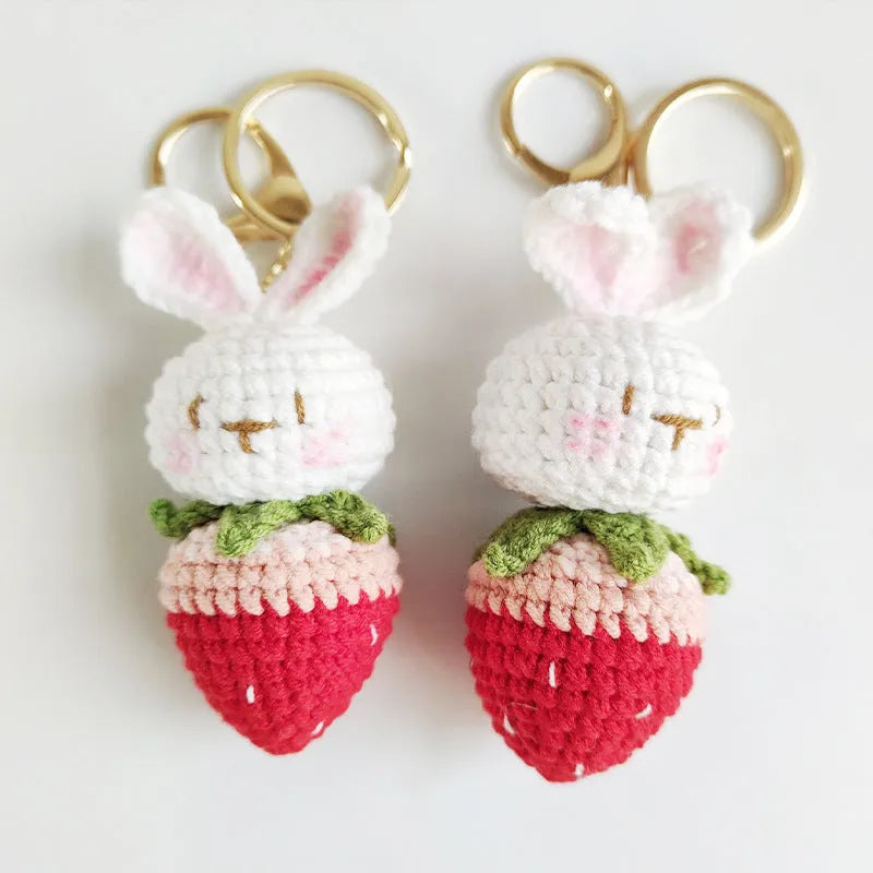 White hand-woven wire pendant with a rabbit strawberry cartoon design and a key loop.