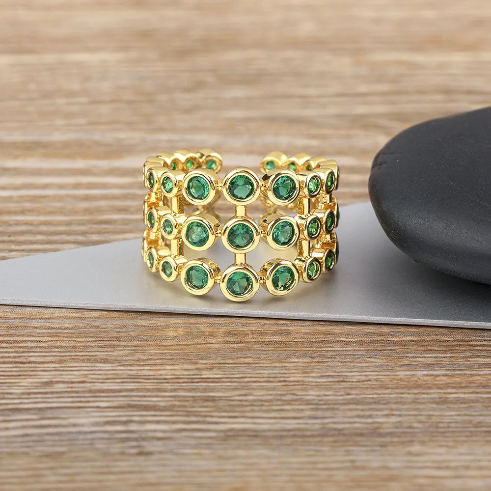 Wide copper ring with green zircon stones and gold plating