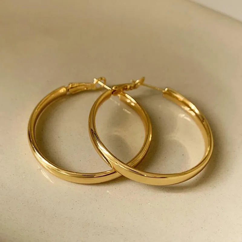 Circular 40mm diameter metal earrings with gold or silver electroplated finish