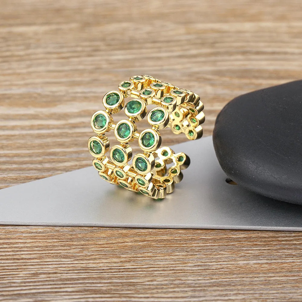 Wide copper ring with green zircon stones and gold plating